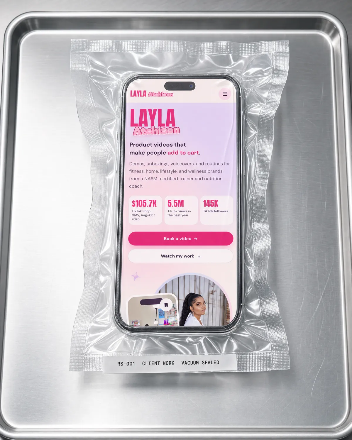 Layla Atchison's portfolio on a phone, vacuum sealed on a steel tray