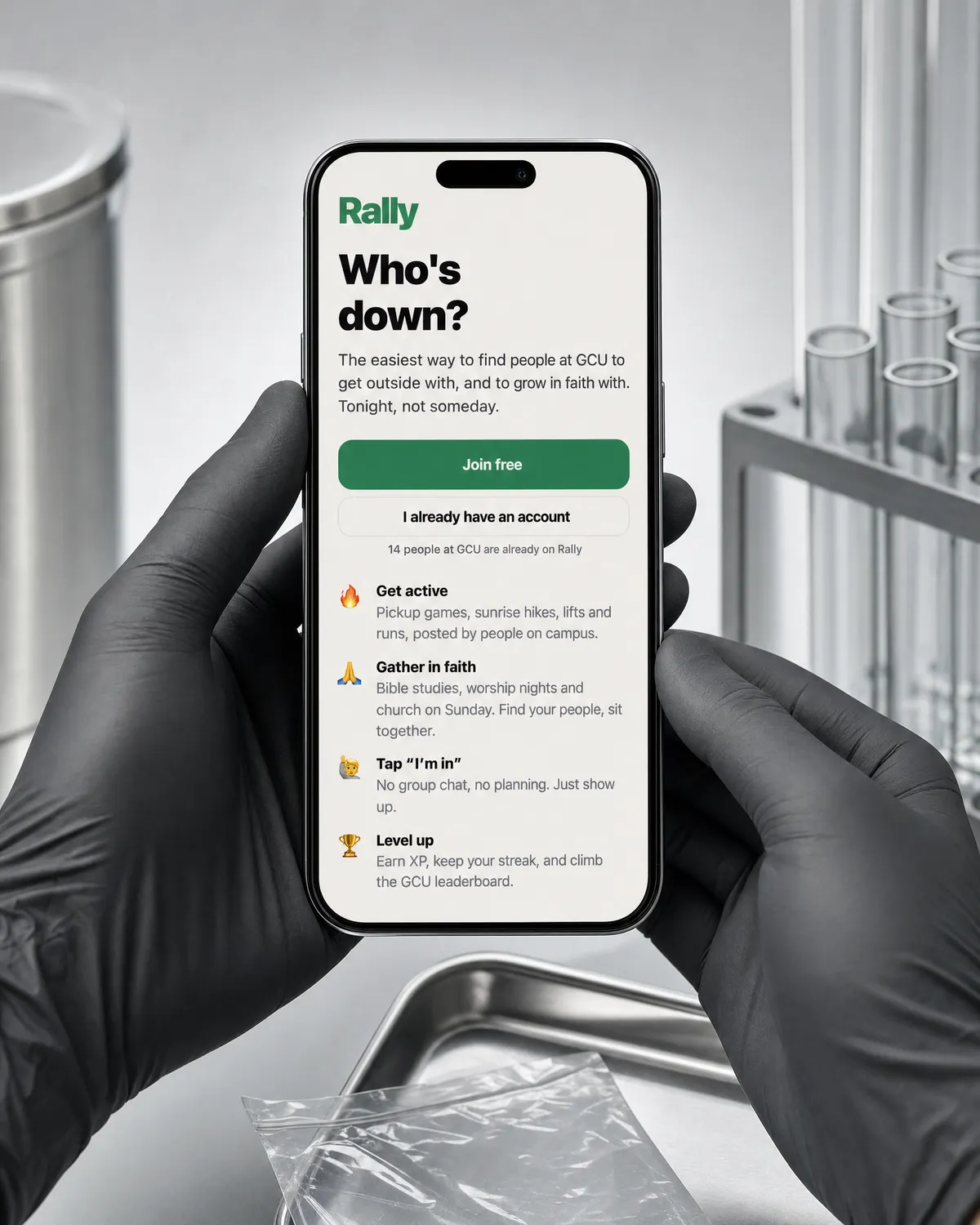 Black gloved hands holding a phone showing the Rally app